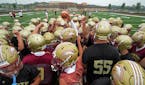 Lakeville South's football team hit the field with a team huddle before the first day of practice Monday morning. Photo: BRIAN PETERSON •brian.peter