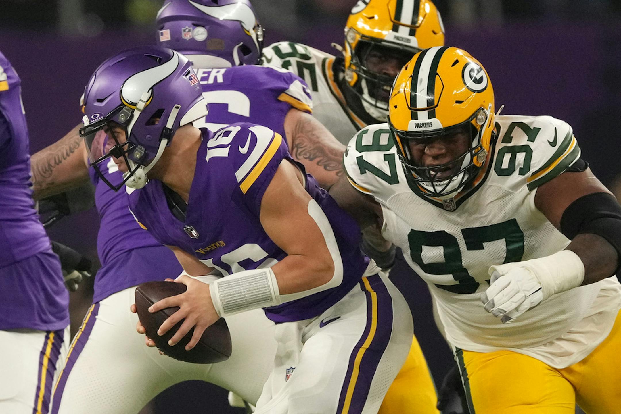 Minnesota Vikings quarterback Jaren Hall (16) scrambles out of the pocket under pressure from Green Bay Packers defensive tackle Kenny Clark (97) in the second quarter of an NFL game between the Minnesota Vikings and the Green Bay Packers Sunday, Dec. 31, 2023 at U.S. Bank Stadium in Minneapolis. ] ANTHONY SOUFFLE • anthony.souffle@startribune.com