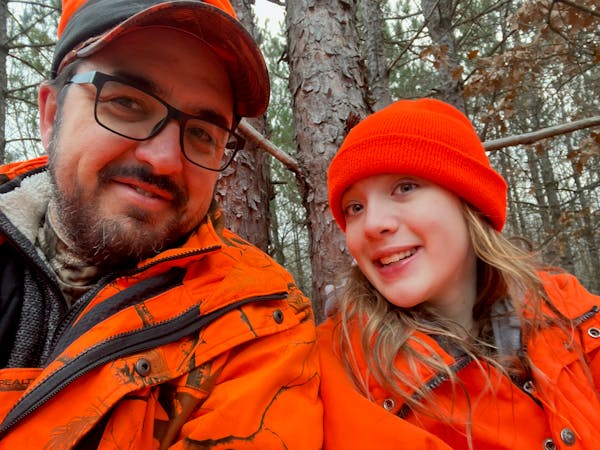 Andrew Weber of Woodbury in a tree stand Saturday morning with daughter Julia, 13. They were in step with a 50-year tradition of deer hunting with clo