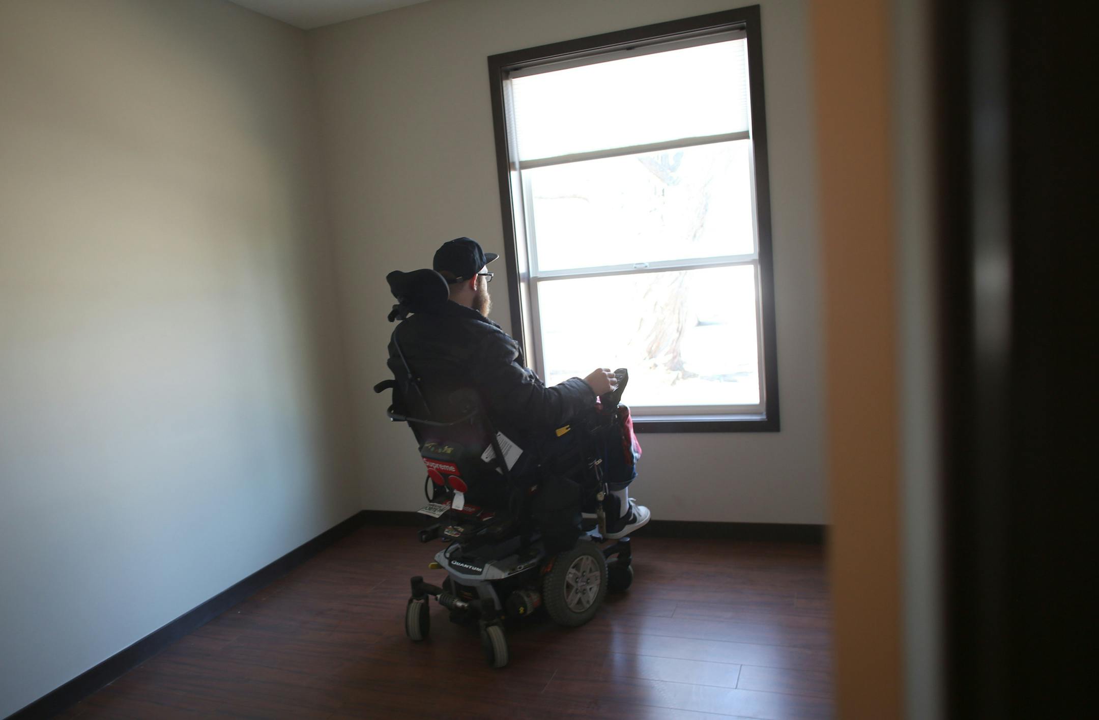 Zach Mohs looked out the window as he toured the new home made to fit his needs. ] (KYNDELL HARKNESS/STAR TRIBUNE) kyndell.harkness@startribune.com Welcome home" reception and ribbon cutting at Zach Mohs' new home in South St. Paul, Saturday, March 29, 2014. Mohs was struck by a hit-and-run driver in 2012 and doctors thought he might not survive. But he pulled through, and now the Builders Association of the Twin Cities Foundation is helping with his recovery by building him an accessible home i