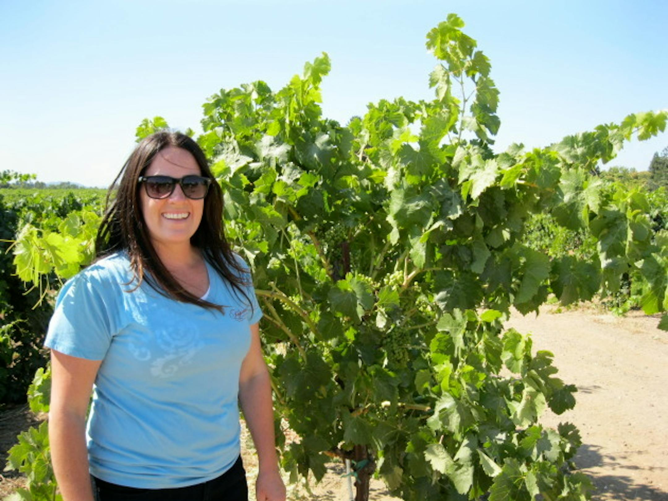 Foppiano winemaker, Natalie West, in front of Petite Sirah vines.