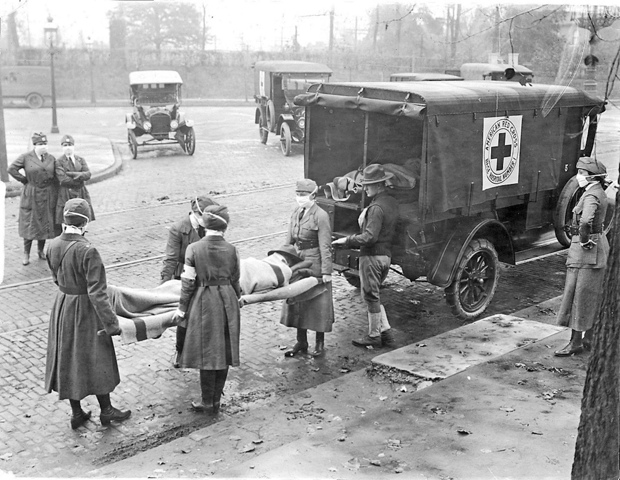 Members of the American Red Cross remove Spanish influenza victims from a house in St. Louis in 1918.