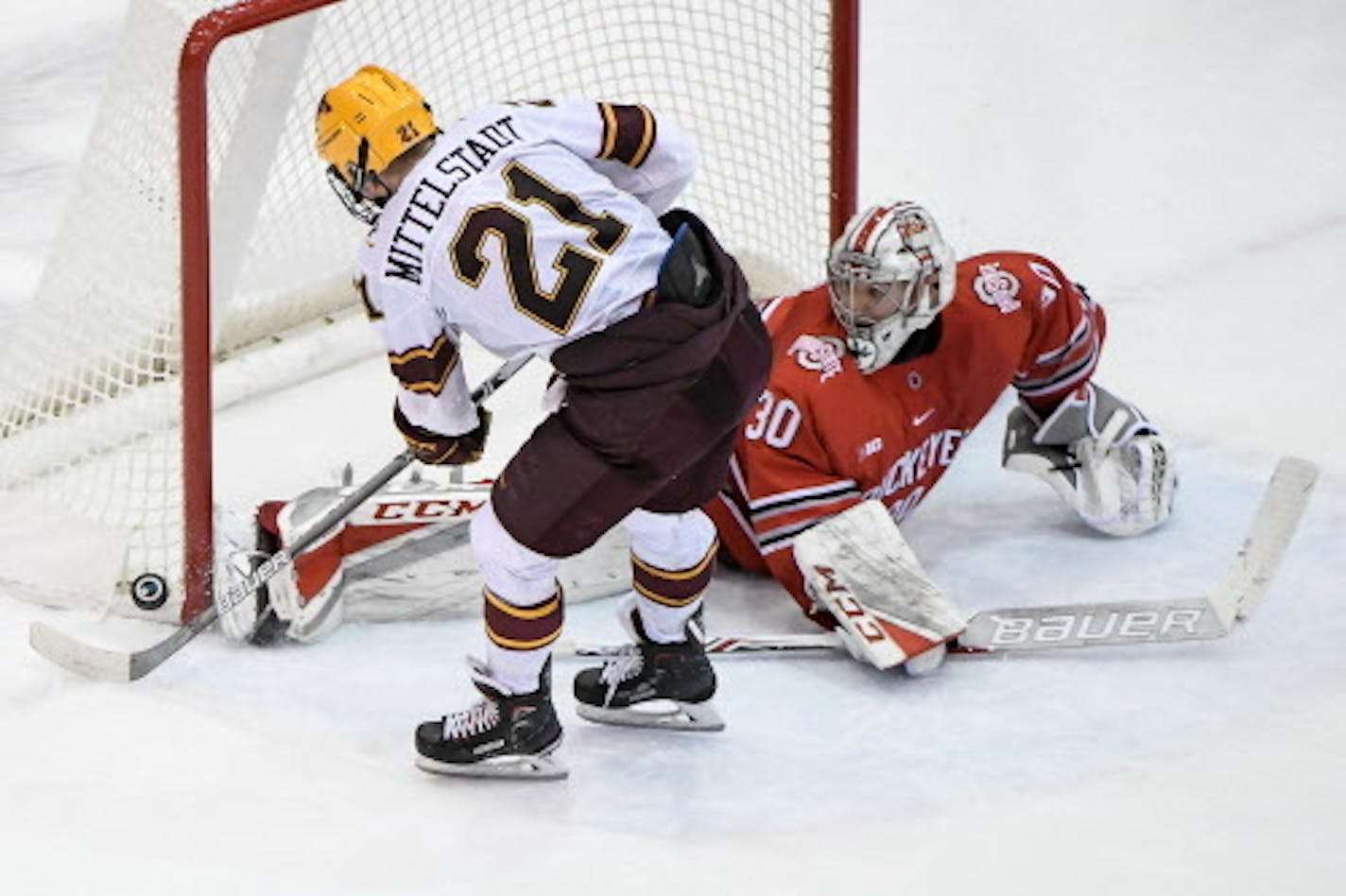 Minnesota Golden Gophers forward Casey Mittelstadt (21) was denied a shootout goal  by the skate of Ohio State Buckeyes goaltender Sean Romeo (30).   ] AARON LAVINSKY ' aaron.lavinsky@startribune.com