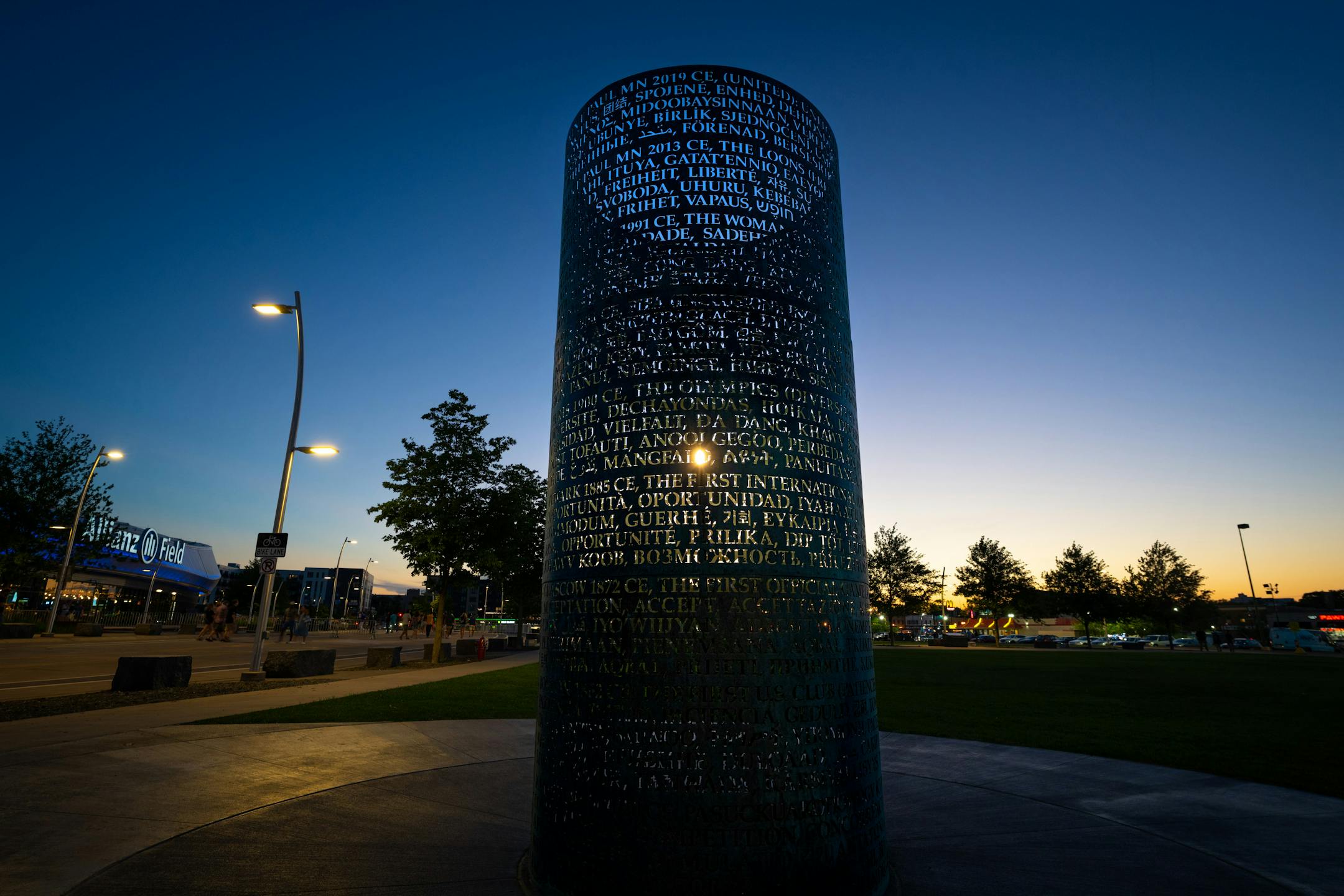 Fans file out of Allianz Stadium after a Loons win against Everton, Wednesday, July 20, 2022, St. Paul, Minn. The OMNIS sculpture by artist Jim Sanborn is located at the north side of Allianz Stadium. It is a cylindrical bronze work with text about the values of soccer written in 80 or so languages; at night, the sculpture lights up from the inside and projects text onto the ground and nearby buildings. The piece was commissioned by Bill McGuire, owner of Minnesota United and former CEO of UnitedHealthcare. ] GLEN STUBBE • glen.stubbe@startribune.com