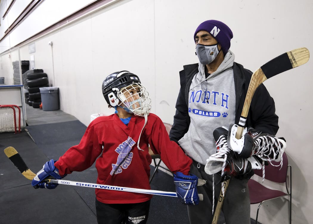 Chris Williams talked to his 8-year-old son, Marko, after a squirts league game at Northeast Ice Arena.