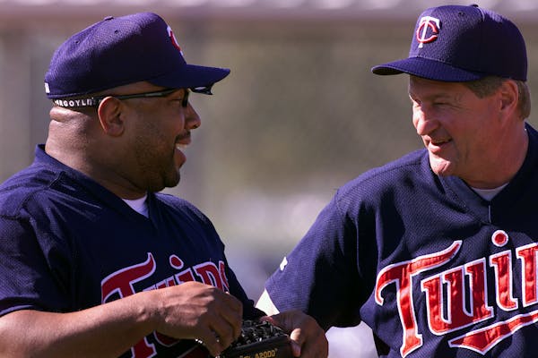 Twins great Kirby Puckett shares a laugh with coach Rick Stelmaszek during the first day of full squard spring training in Fort Myers.