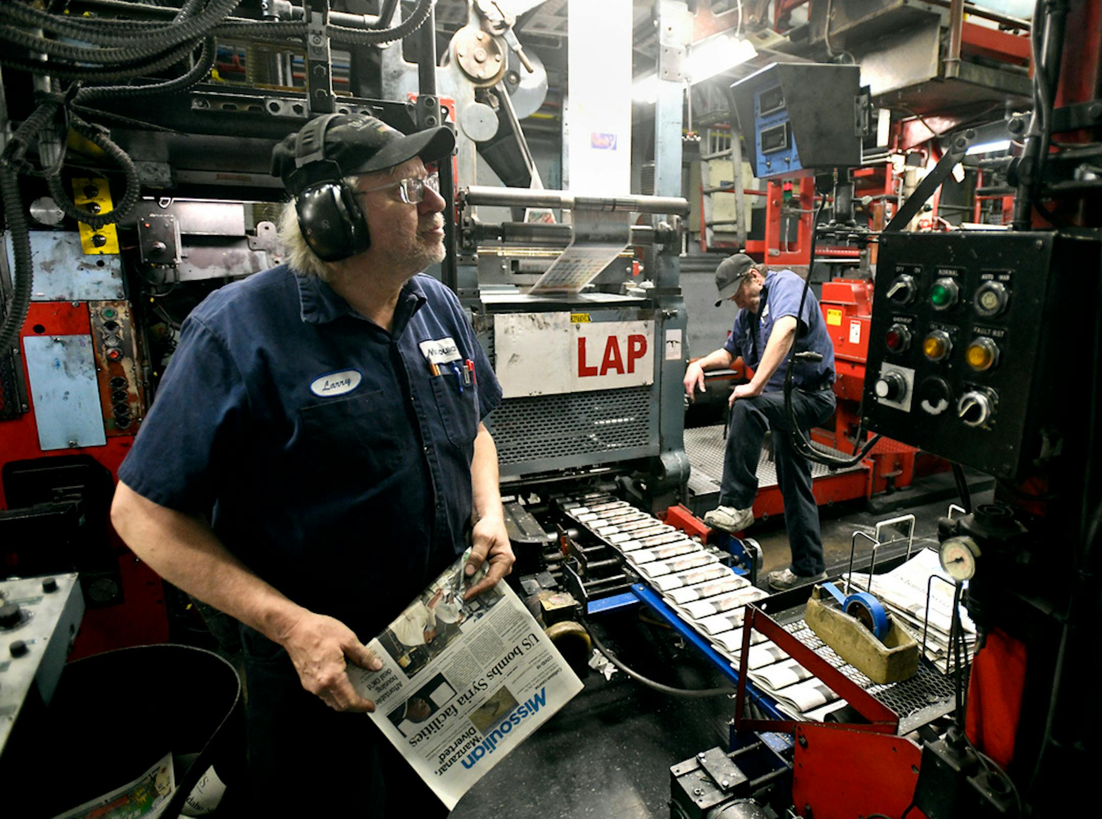 Press operator Larry Sorenson, left, watches the copy counter as he and operator Todd Matthews run the Missoulian press on Feb. 26, 2021 in Missoula, Mont. The press will stop operating at the end of March as printing of the Missoulian moves to the Helena Independent facility in Helena, Mont. (Tom Bauer/The Missoulian via AP)