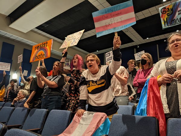 Teacher Lisa Sackett joined students Gray Dodds and Andru Thornton to protest the school board presentation by an anti-LGBTQ group on March 14 at Beck