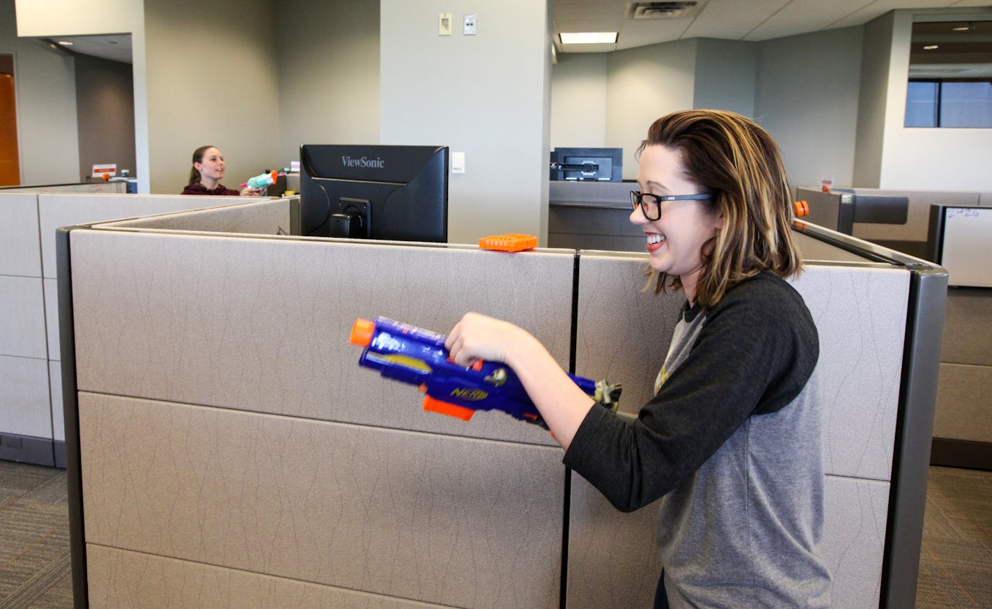 Britt Wicklund, the operations coordinator, was playing the office pressure gun with her coworkers on the top floor. ] XAVIER WANG &#x2022; xavier.wang@startribune.com Employees in the company ALARM.COM use and live in the office space in a creative and fun way, which makes the office doesn't resemble the traditional call center. The photos were taken on Thursday June 1, 2017 in Bloomington.