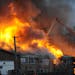 Firefighters battle a large fire at an apartment building in Detroit, Wednesday, March 5, 2014. There were no immediate reports of any deaths caused b