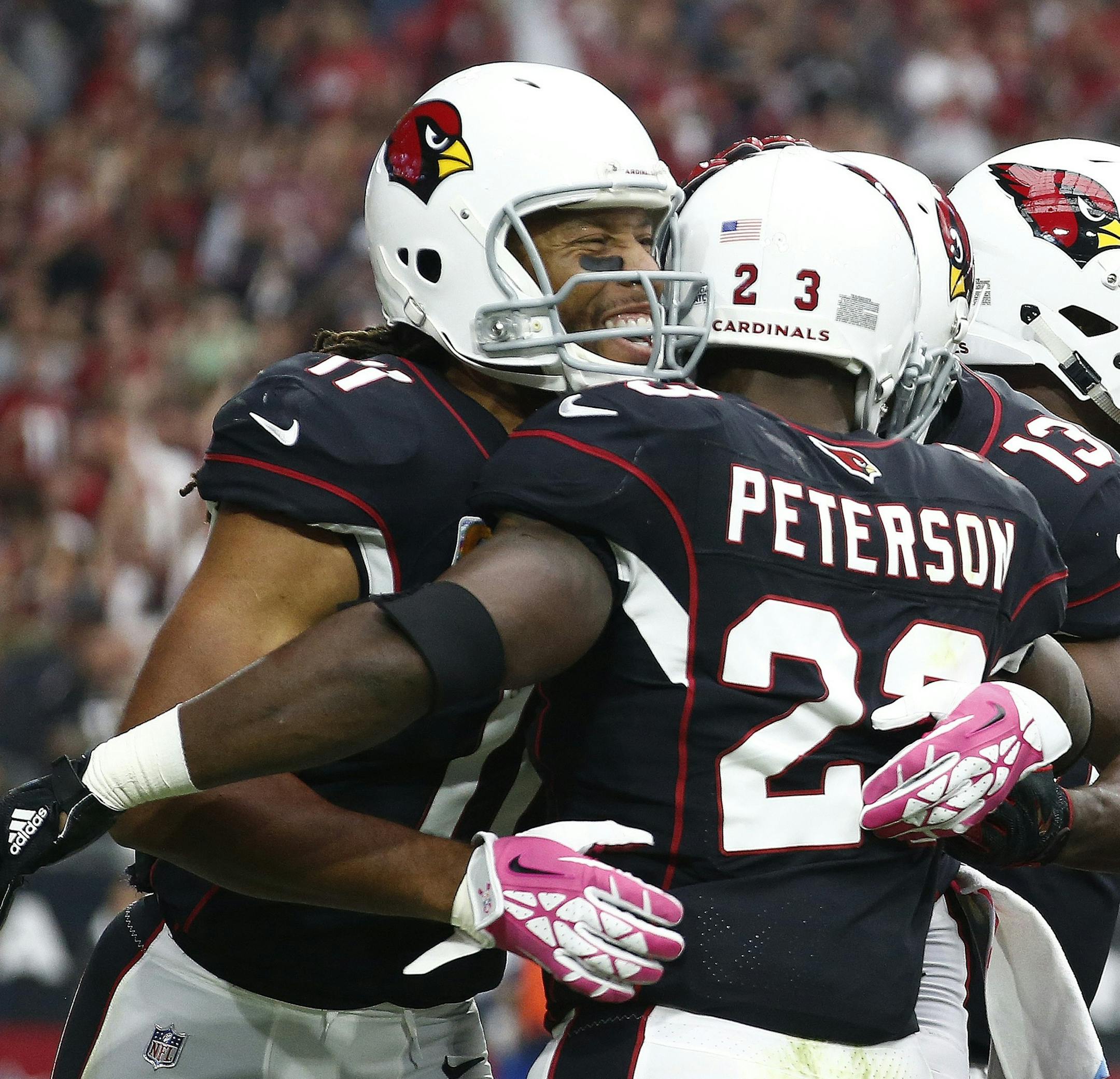 Arizona Cardinals wide receiver Larry Fitzgerald (11) celebrates a touchdown against the Tampa Bay Buccaneers by Cardinals running back Adrian Peterson, right, during the first half of an NFL football game Sunday, Oct. 15, 2017, in Glendale, Ariz. (AP Photo/Ralph Freso)