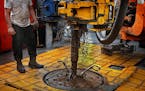 The drilling rig floor is slick with grease and oil.] (JIM GEHRZ/STAR TRIBUNE) / December 17, 2013, Watford City, ND &#x201a;&#xc4;&#xec; BACKGROUND I