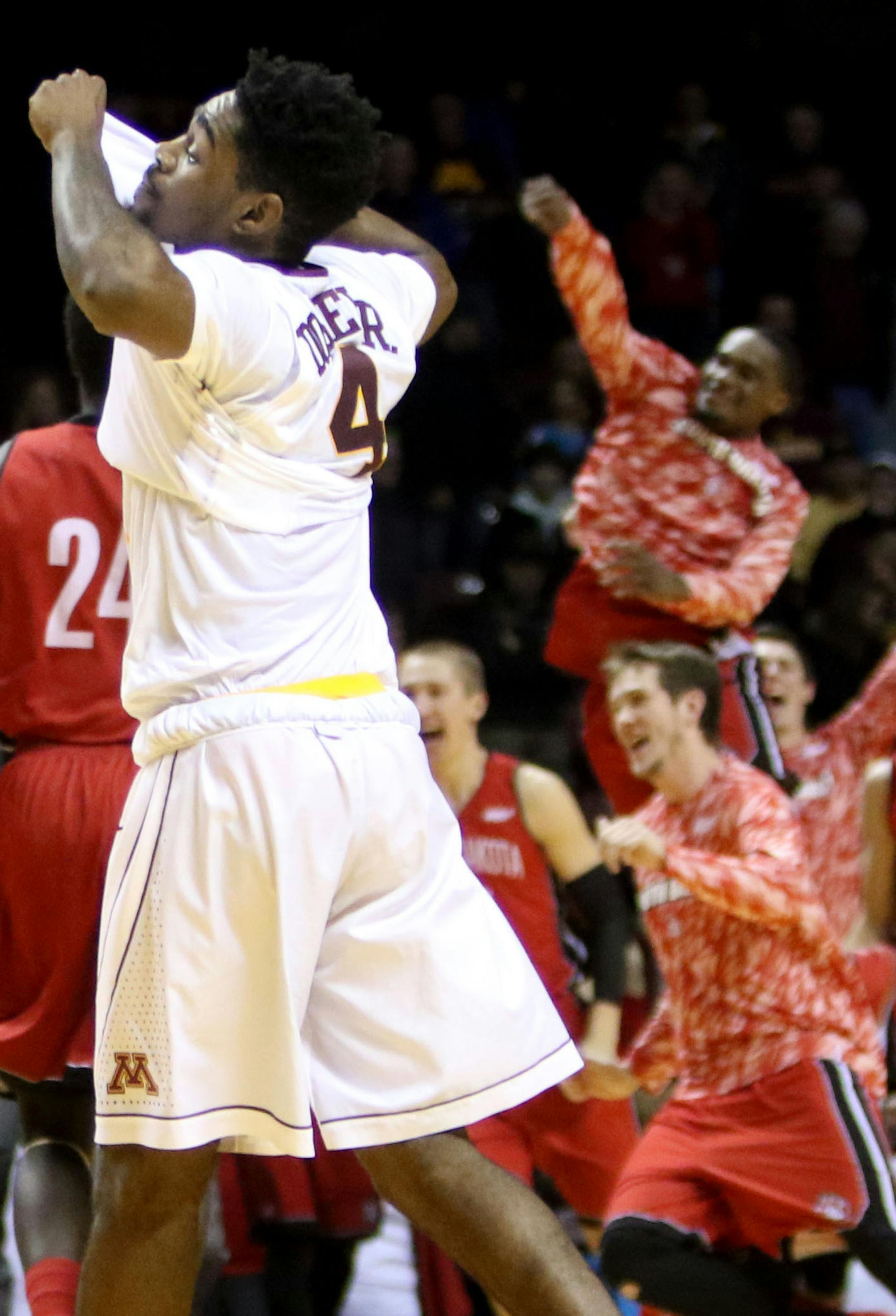 The University of Minnesota's Kevin Dorsey Jr. (4) walks off the court as University of South Dakota players celebrate their 85-81 double overtime win at Williams Arena Saturday, Dec. 5, 2015, in Minneapolis, MN. ](DAVID JOLES/STARTRIBUNE)djoles@startribune.comUniversity of Minnesota men&#xed;s basketball versus South Dakota at Williams Arena Saturday, Dec. 5, 2015, in Minneapolis, MN.