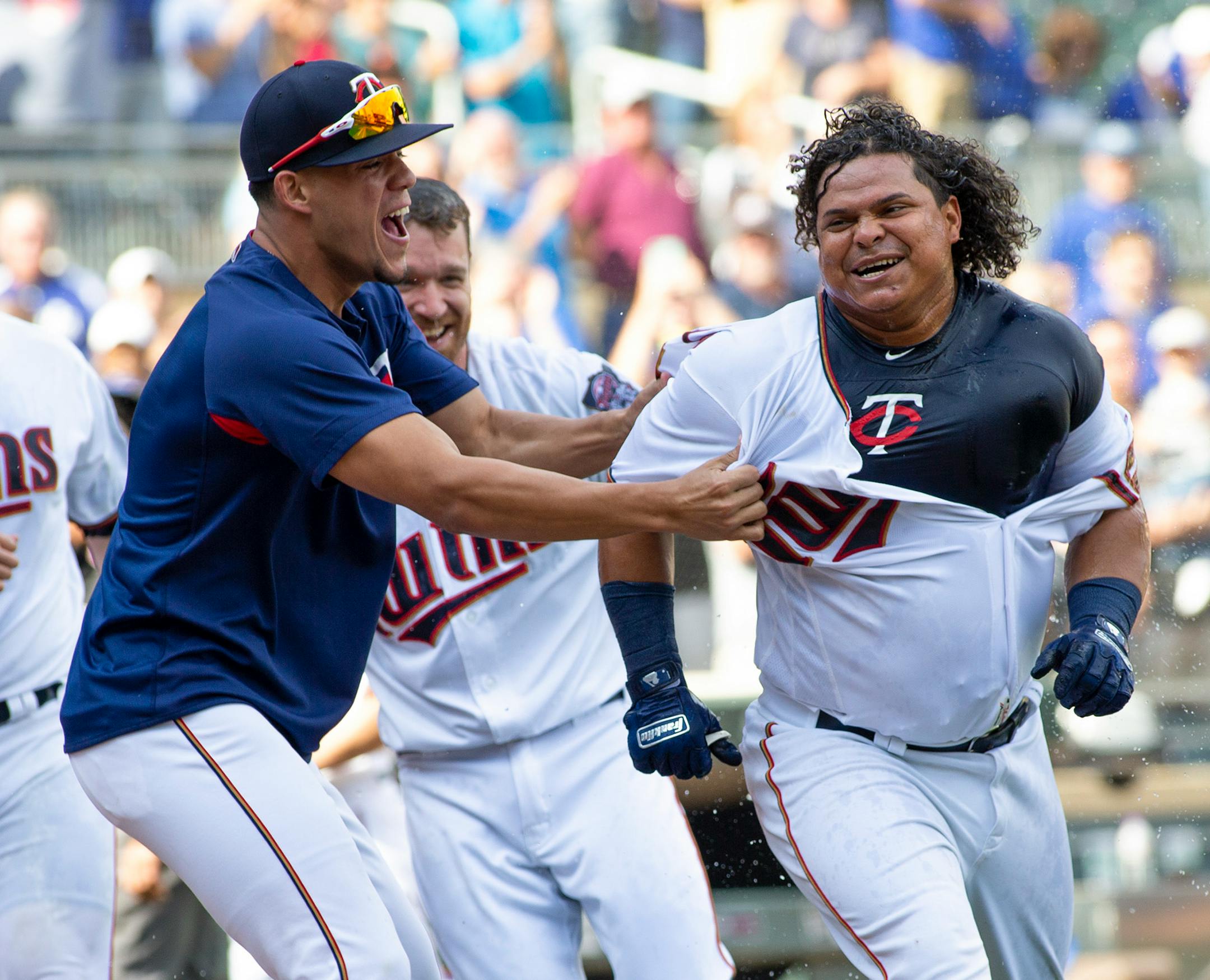 Minnesota Twins Willians Astudillo, right, is mobbed by teammate Jose Berrios after hitting a 2-run home run during the ninth inning of a baseball game against the Kansas City Royals, Sunday, Sept. 9, 2018, in Minneapolis. Minnesota won 3-1. (AP Photo/Paul Battaglia)