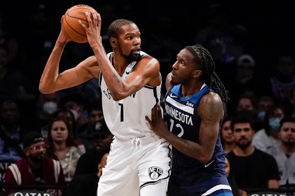 The Timberwolves' Taurean Prince, right, defends against Brooklyn Nets' Kevin Durant during the first half of a preseason game Thursday