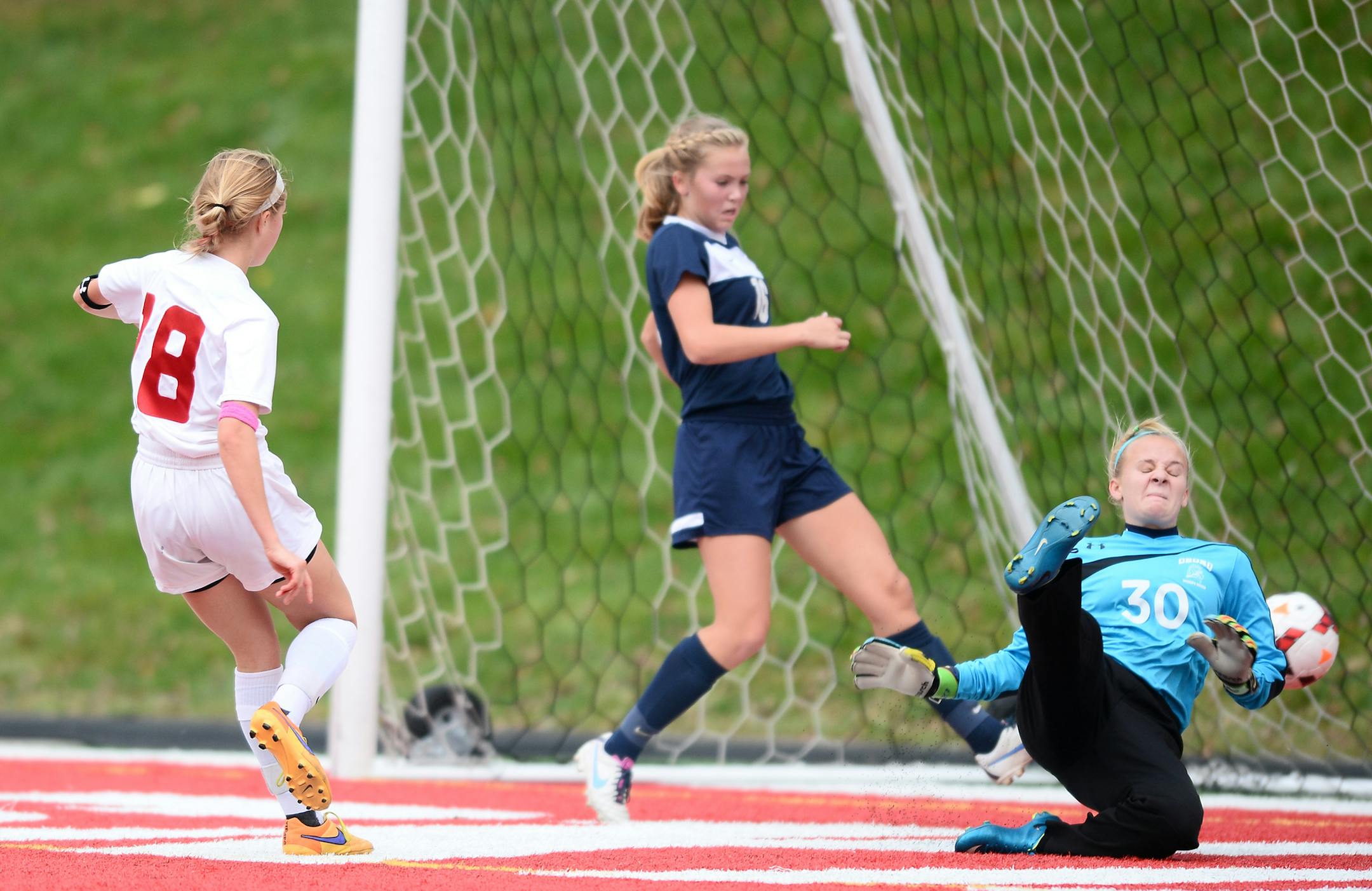 Benilde-St. Margaret's midfielder Madison Stoks (18) scored a goal on Orono goalie Jessica Woessner (30) in the second half. ] (AARON LAVINSKY/STAR TRIBUNE) aaron.lavinsky@startribune.com Benilde-St. Margaret's played Orono in the girls' 1A soccer state championship on Thursday, Nov. 5, 2015 at Husky Stadium at St. Cloud University. Benilde-St. Margaret's won 4-2.