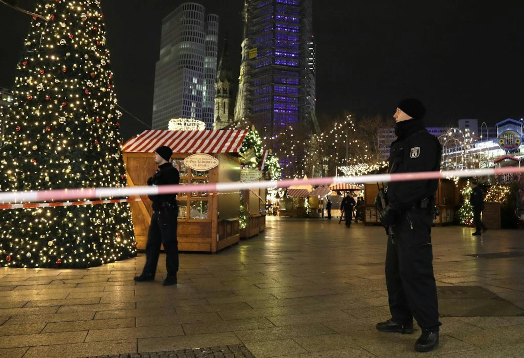 Police guard a Christmas market after a truck ran into the crowded Christmas market in Berliin Berlin, Germany, Monday, Dec. 19, 2016.