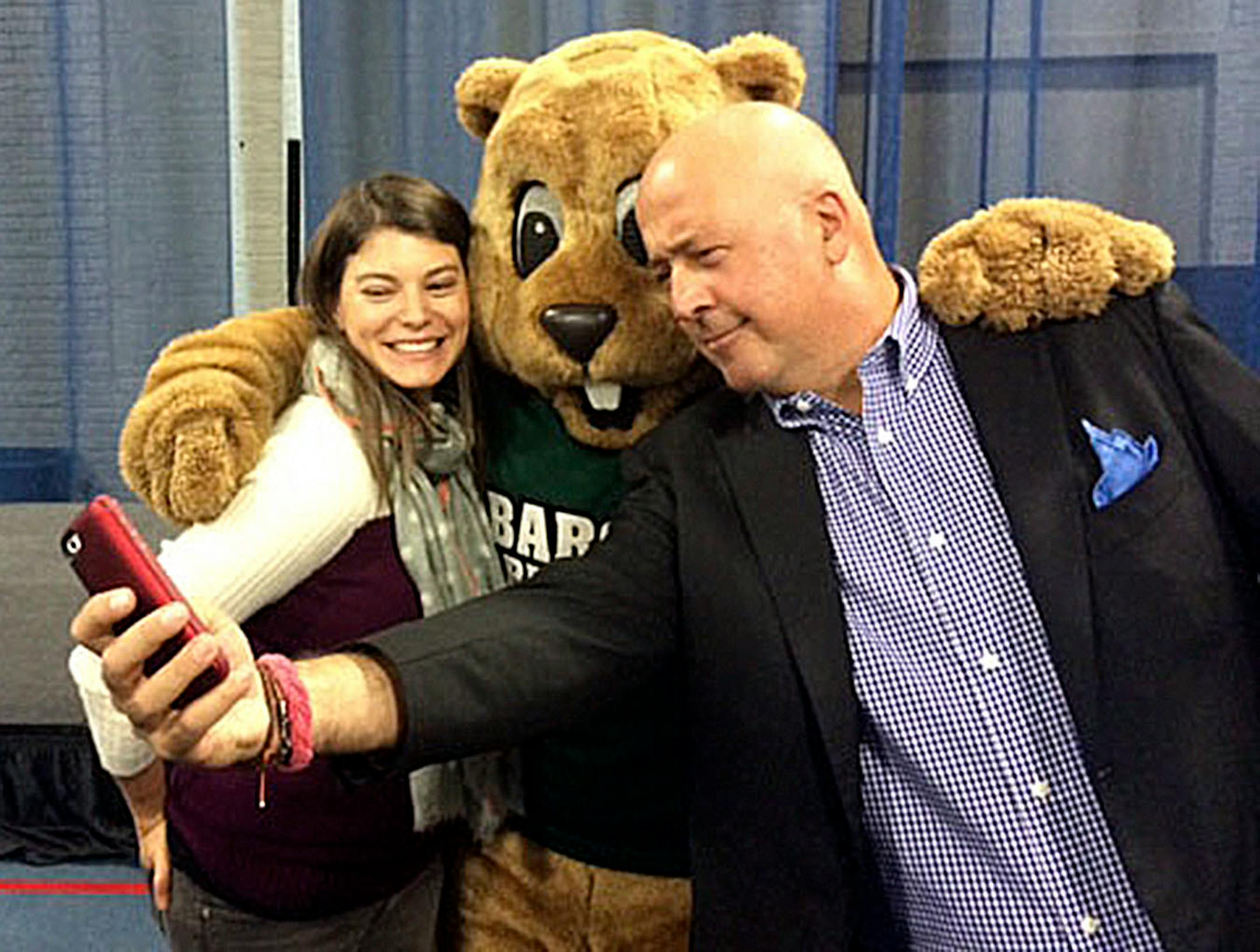 Andrew Zimmern in photographed taking a selfie with fans.