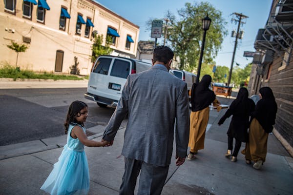 After having lunch at Football Pizza, Sher Mohammad Mulakhail takes daughter Maryam, 5, home along with his other daughters in Minneapolis, Minn., on 