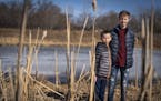 Emerson Olson, 14, and his brother Everett, 11, posed for a portrait near the pond where they helped rescue a woman in Brooklyn Park. ] LEILA NAVIDI &