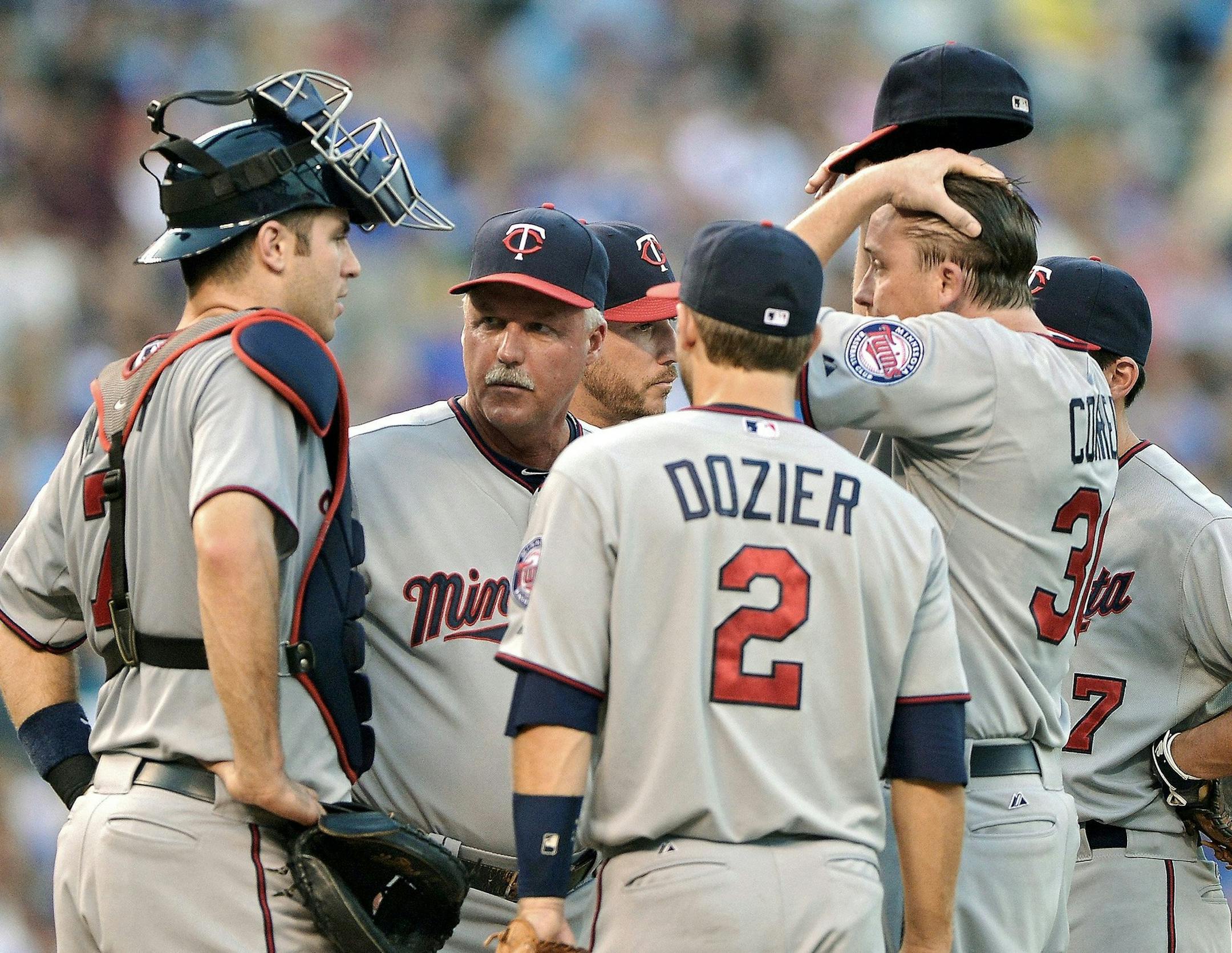 Minnesota Twins starting pitcher Kevin Correia (30) listens in on a visit to the mound by Twins pitching coach Rick Anderson in the second inning against the Kansas City Royals at Kauffman Stadium in Kansas City, Missouri, Monday, August 5, 2013. (John Sleezer/Kansas City Star/MCT)
