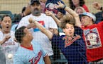 Fans reach for a foul ball in the fourth inning.
