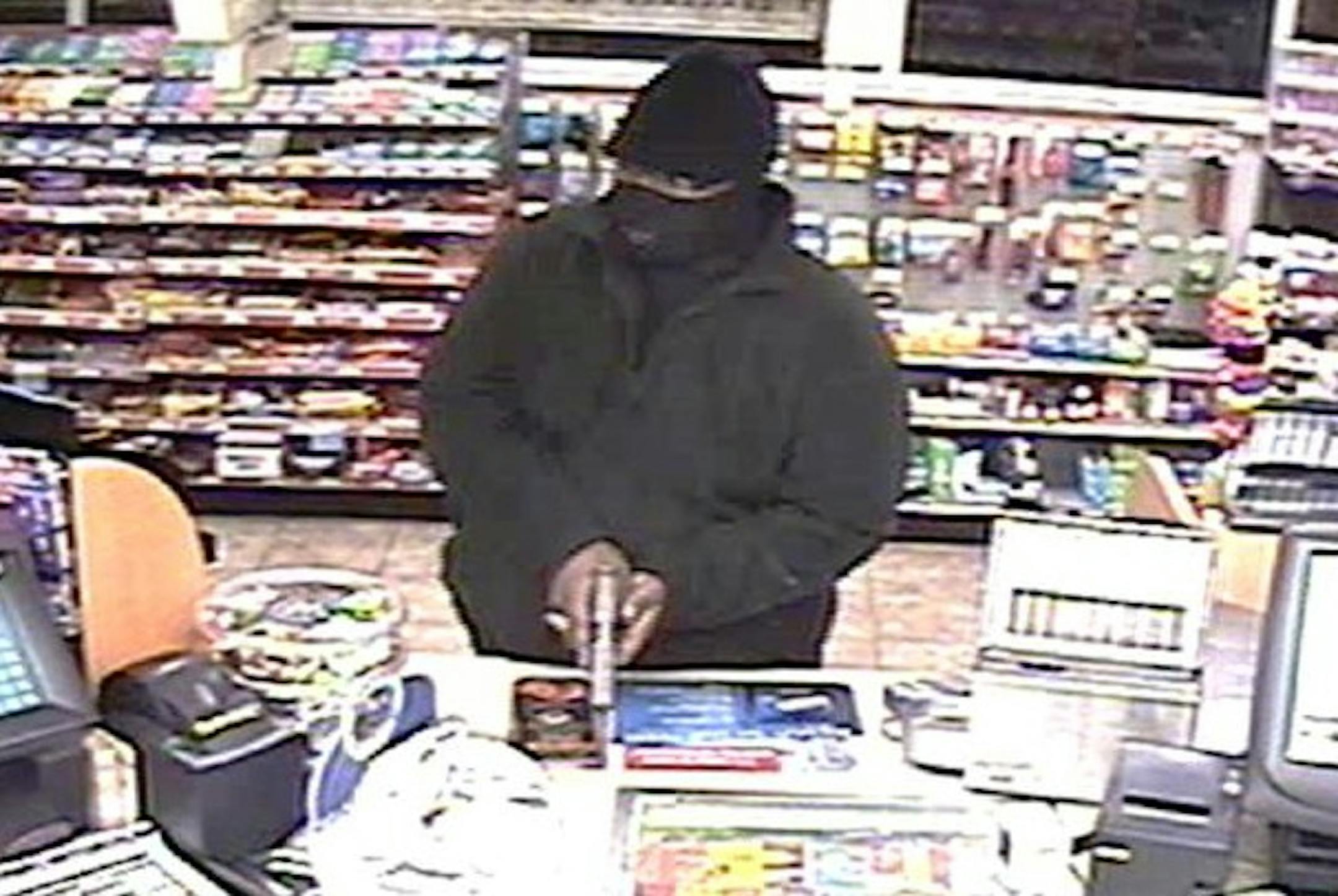 This man, shown robbing a SuperAmerica store at 4320 E. Lake Street in Minneapolis, is suspected in five store hold-ups on Tuesday, Dec. 31.