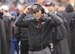 Cincinnati Bengals defensive coordinator Mike Zimmer adjusts his head set in the second half of an NFL wild-card playoff football game against the San