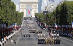 U.S troops march down the Champs Elysees avenue, with the Arc de Triomphe in background, during the Bastille Day parade in Paris, Friday, July 14, 201