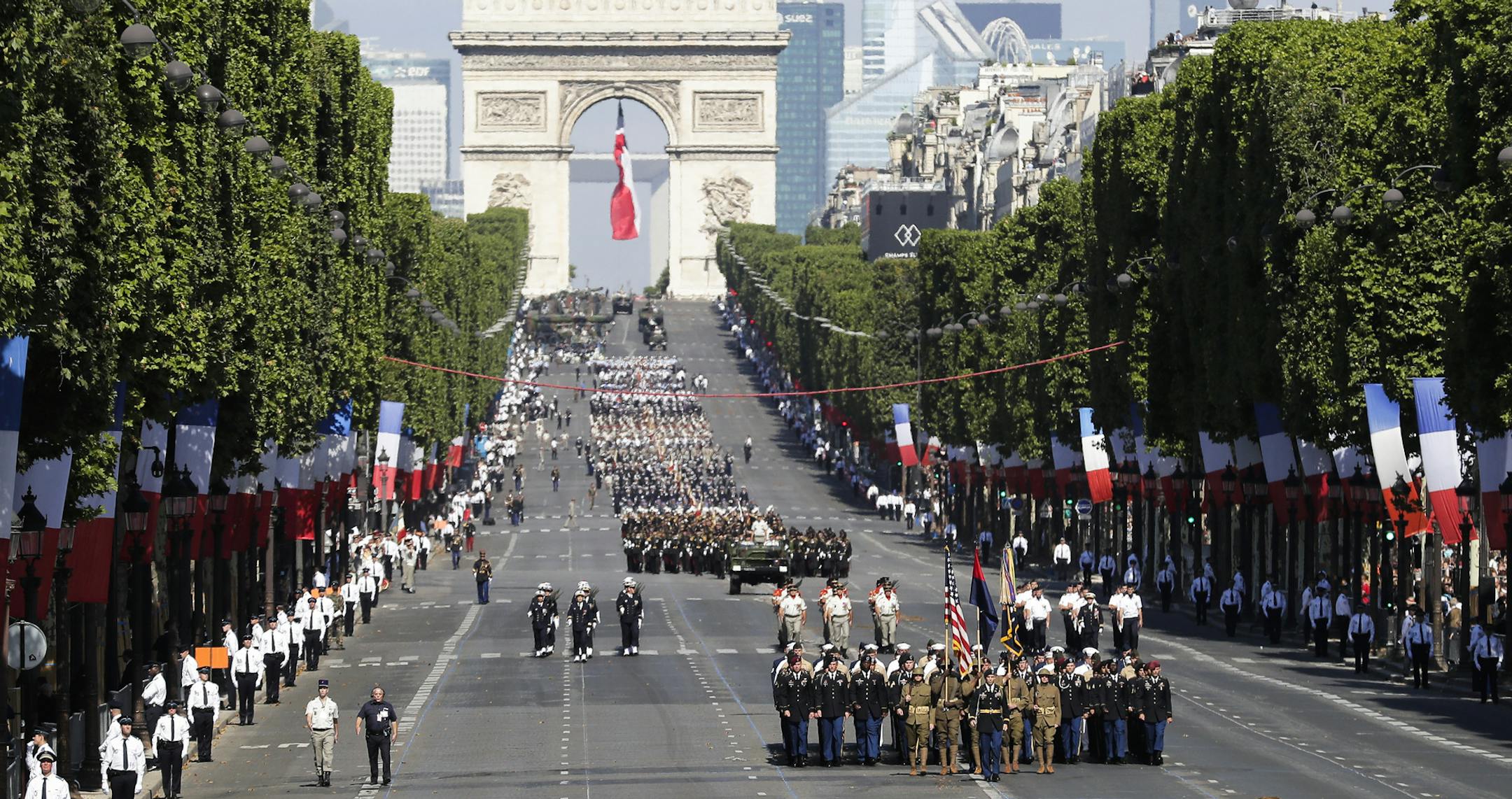 U.S troops march down the Champs Elysees avenue, with the Arc de Triomphe in background, during the Bastille Day parade in Paris, Friday, July 14, 2017. Paris has tightened security before its annual Bastille Day parade, which this year is being opened by American troops with President Donald Trump as the guest of honor to commemorate the 100th anniversary of the United States' entry into World War I. (AP/Photo/Markus Schreiber)