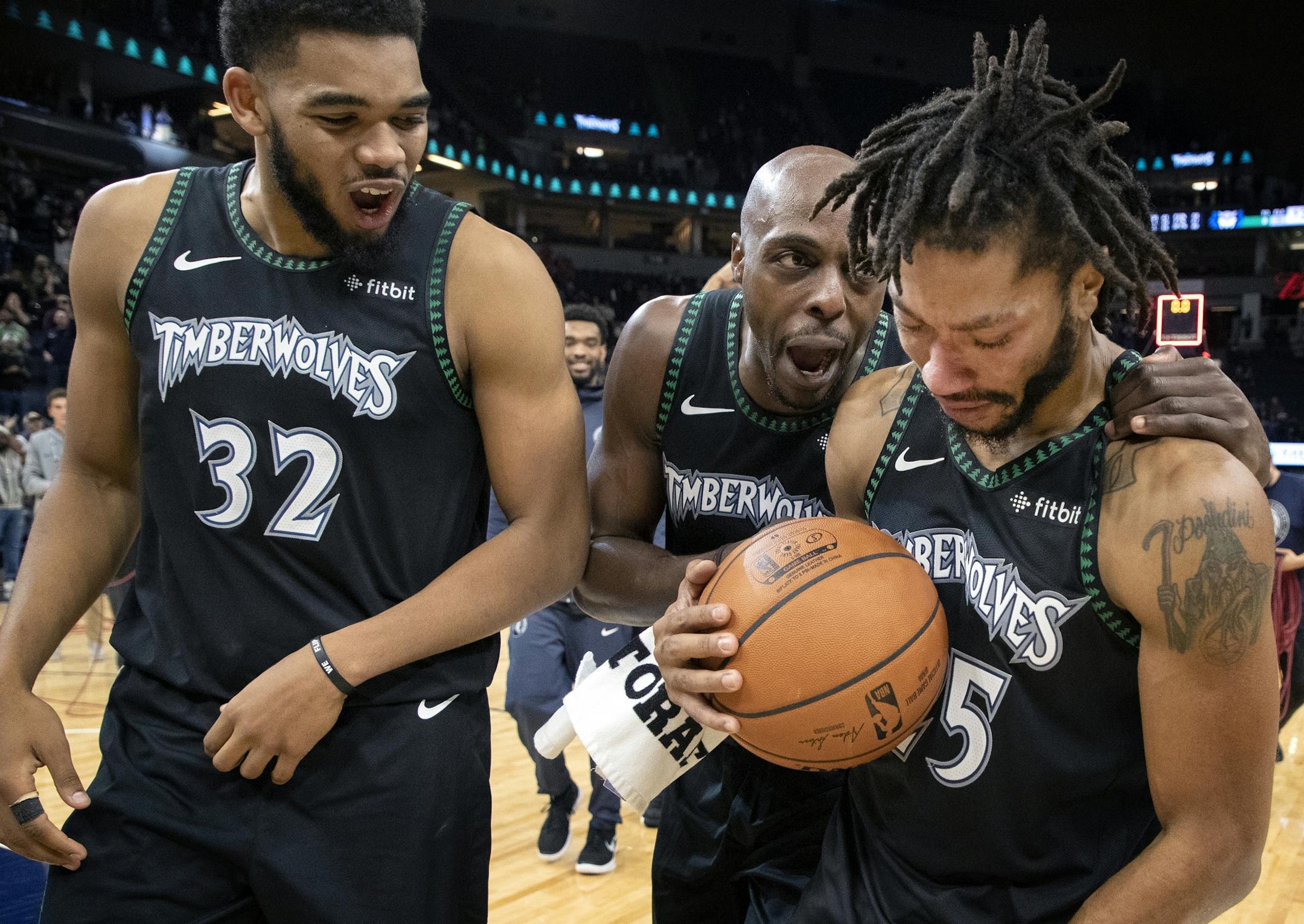 Derrick Rose was surrounded by teammates at the end of the game. Rose scored a career high 50 points.