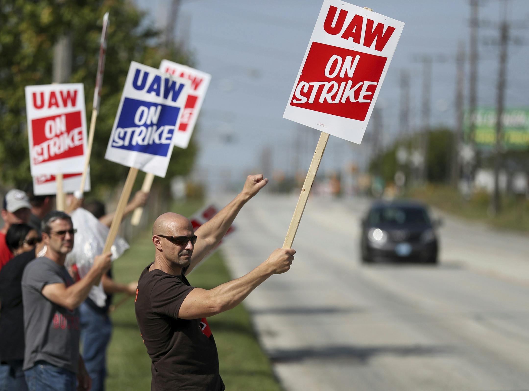 Carl Cvetkovich, front, joins dozens of fellow striking UAW workers outside the GM Parma facility in Parma, Ohio, Monday, Sept. 16, 2019. (Marvin Fong/The Plain Dealer via AP)