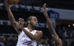 Minnesota Timberwolves forward Andrew Wiggins (22) passes the ball over Charlotte Hornets guard Dwayne Bacon during the second half of an NBA basketba