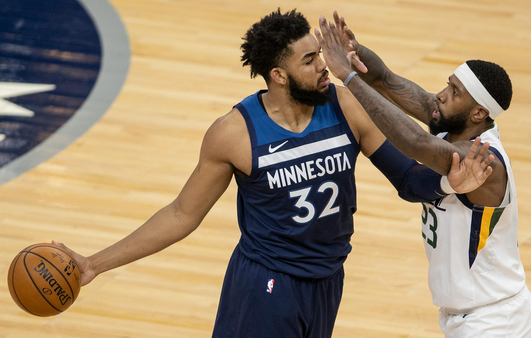 Karl-Anthony Towns (32) of the Minnesota Timberwolves was defended by Royce O'Neale (23) of the Utah Jazz fought for the ball in the second quarter.