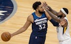 Karl-Anthony Towns (32) of the Minnesota Timberwolves was defended by Royce O'Neale (23) of the Utah Jazz fought for the ball in the second quarter.