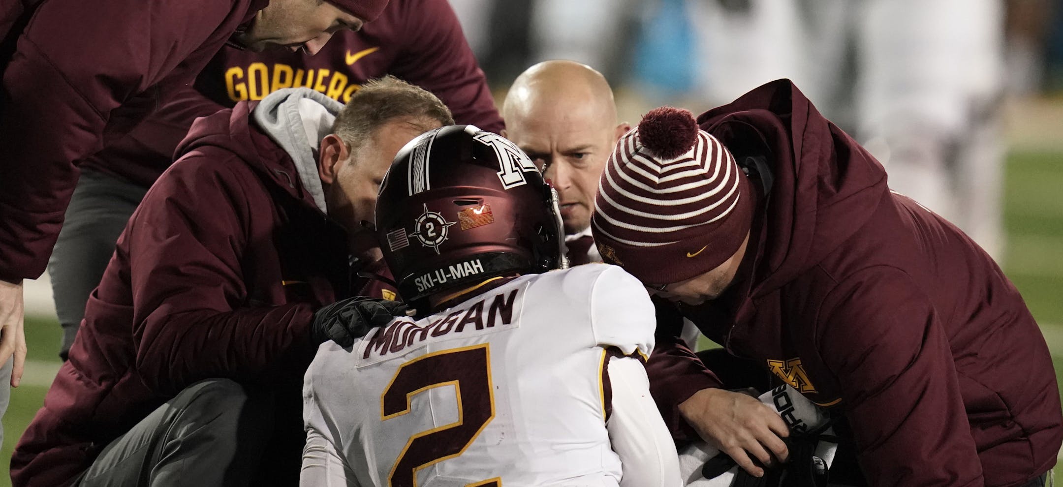 Football coach P.J. Fleck and Gophers trainers attended to quarterback Tanner Morgan (2) after a hard sack in the fourth quarter in Saturday's 23-19 loss to Iowa at Kinnick Stadium. Morgan's availability for the Northwestern game is still uncertain.