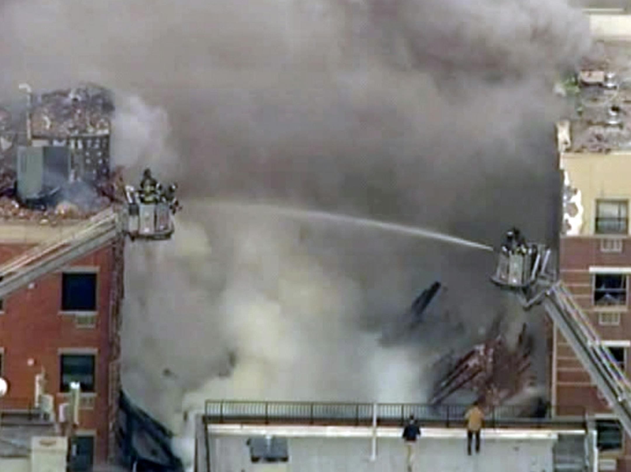 In this image taken from video from WABC, firefighters battle a blaze at the site of a possible explosion and building collapse in the East Harlem neighborhood of New York, Wednesday, March 12, 2014.