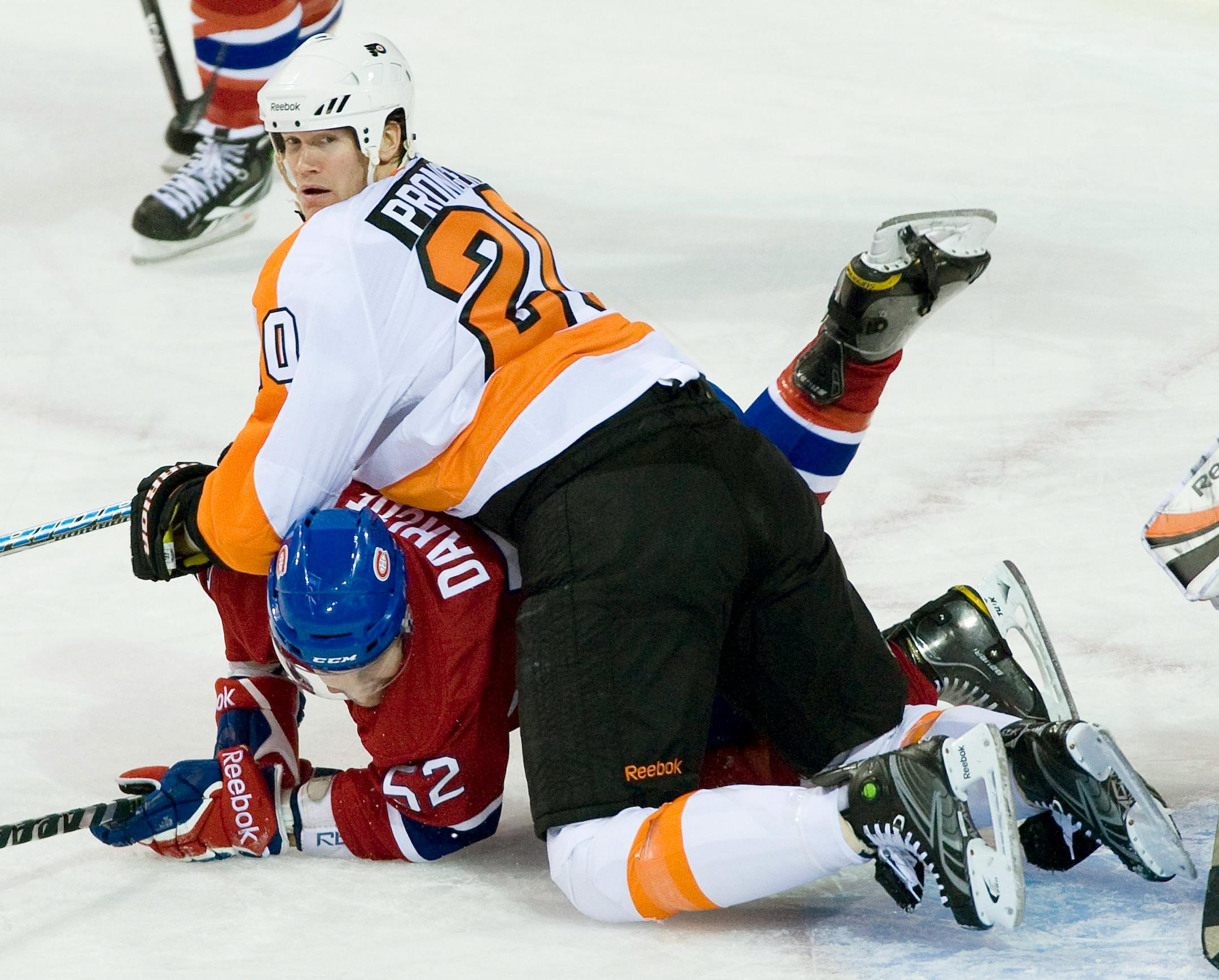 Philadelphia Flyers Chris Pronger, top, smothers Montreal Canadiens' Mathieu Darche during second period NHL hockey action in Montreal, Wednesday, Dec. 15, 2010. (AP Photo/The Canadian Press, Graham Hughes)