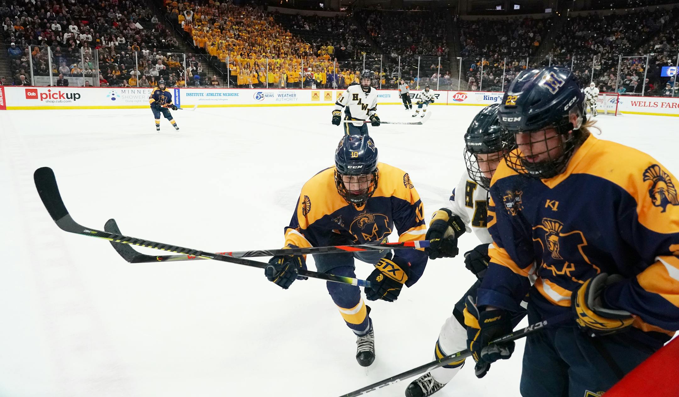 Mahtomedi's Adam Johnson (10) and Dylan Duckson (22) fought Hermantown defenseman Jackson Lucia (4) for the puck