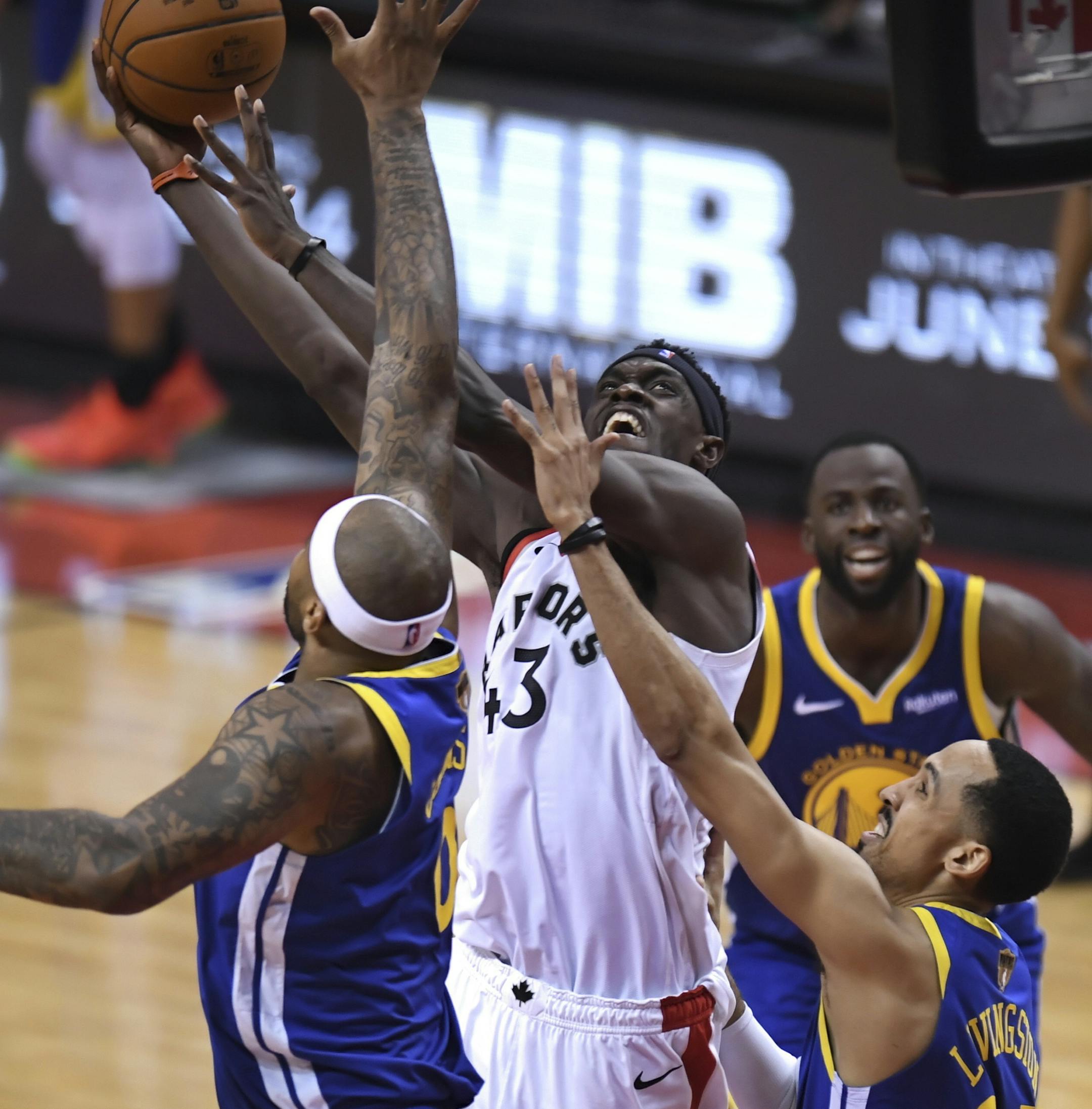 Toronto Raptors forward Pascal Siakam (43) scores as Golden State Warriors center DeMarcus Cousins (0) and guard Shaun Livingston, right, defend during the second half of Game 1 of basketball’s NBA Finals, Thursday, May 30, 2019, in Toronto. (Frank Gunn/The Canadian Press via AP)