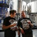 Bartender Amy "Scar" Ronning, left, and cellar master Michael Nelson chat and drink beer during an employee walk-through of Surly Brewing Co.'s new de