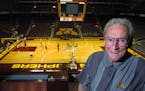 Ray Christensen, at Williams Arena shortly before his retirement in 2001, became synonymous with U football and basketball broadcasts during a half-ce