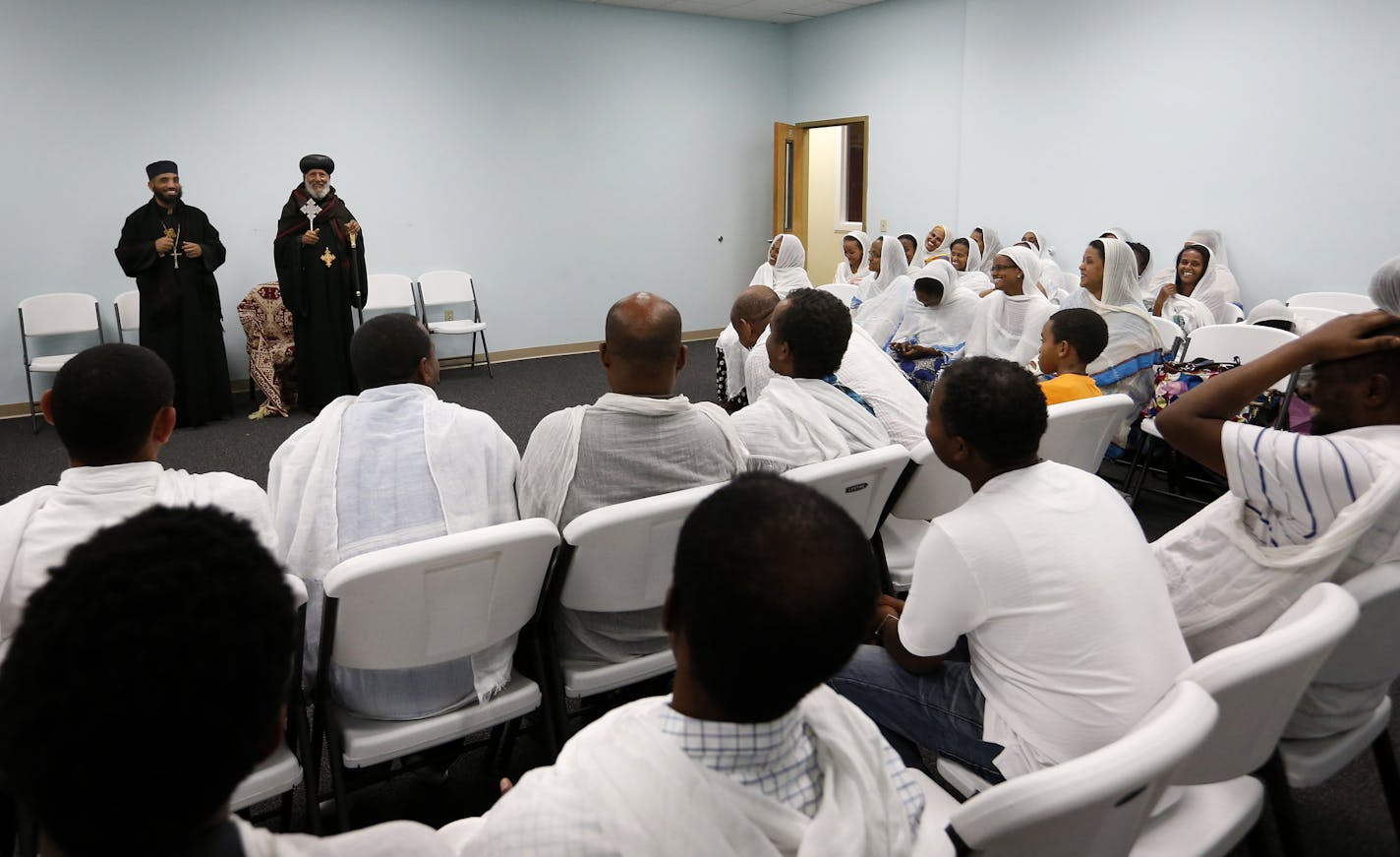 A gathering in one of the meeting rooms at the Ethiopian Orthodox Tewahedo Church in Minneapolis. A building that once housed an IT supplier on Minnehaha Avenue has been purchased by an Ethiopian group and transformed into a church. ] CARLOS GONZALEZ cgonzalez@startribune.com - August 26, 2015, Minneapolis, MN, A building that once housed an IT supplier on Minnahaha Avenue has been purchased by an Ethiopian group and transformed into a Christian church. Ethiopian Orthodox Tewahedo