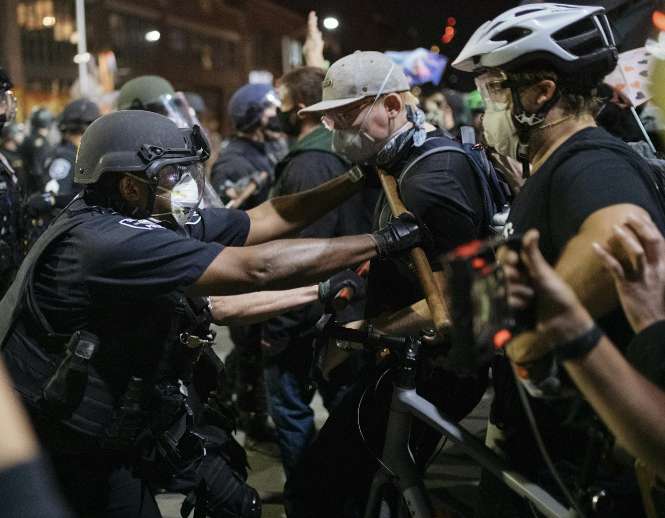 Police push back protesters in the Capitol Hill neighborhood in Seattle, July 25, 2020. Weeks of violent clashes between federal agents and protesters in Portland, Ore., galvanized thousands of people to march through the streets of American cities on Saturday. (Grant Hindsley/The New York Times)