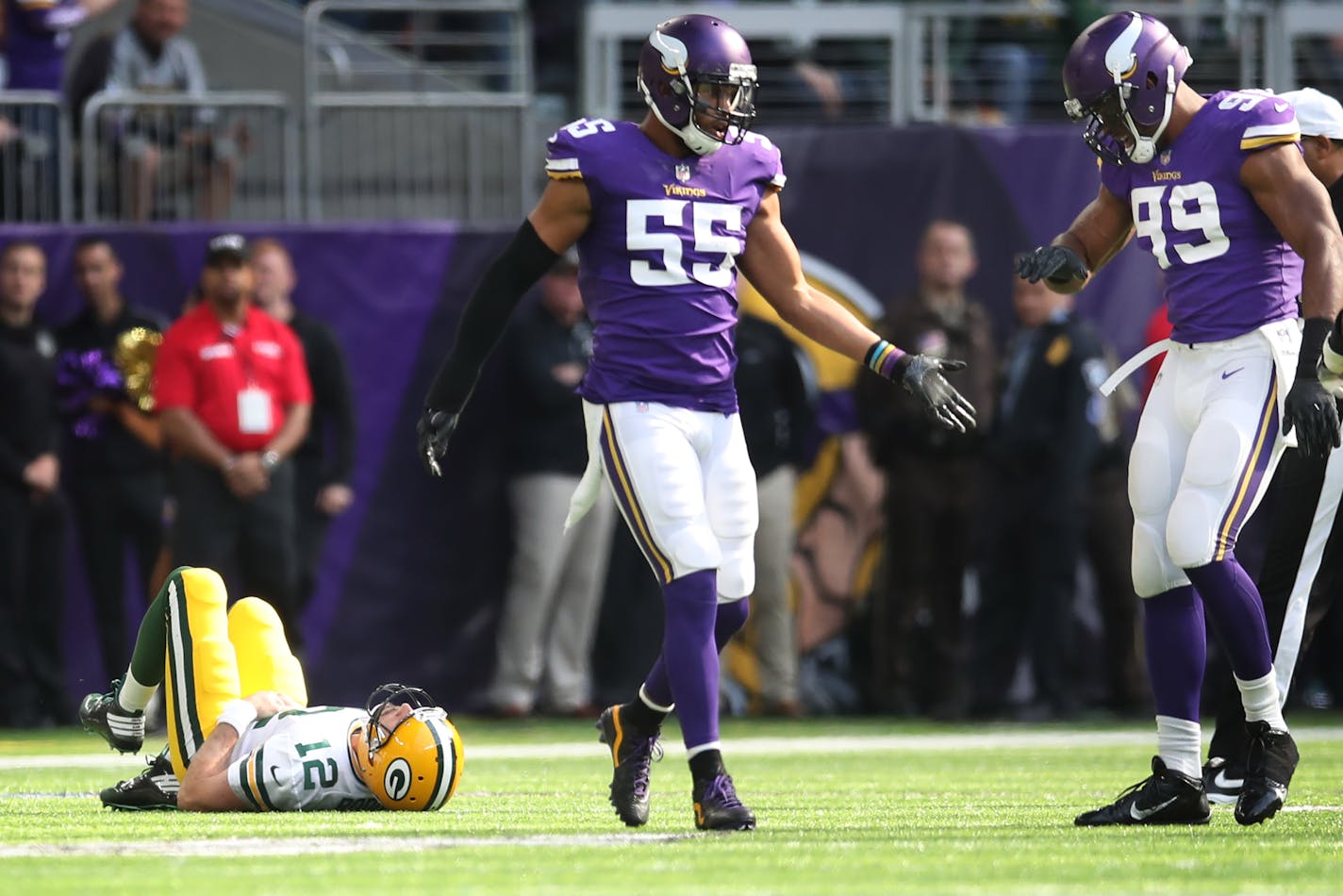 Minnesota Vikings outside linebacker Anthony Barr (55) celbrated with Danielle Hunter as Green Bay Packers quarterback Aaron Rodgers (12) laid on the field after he tackled him in the first quarter