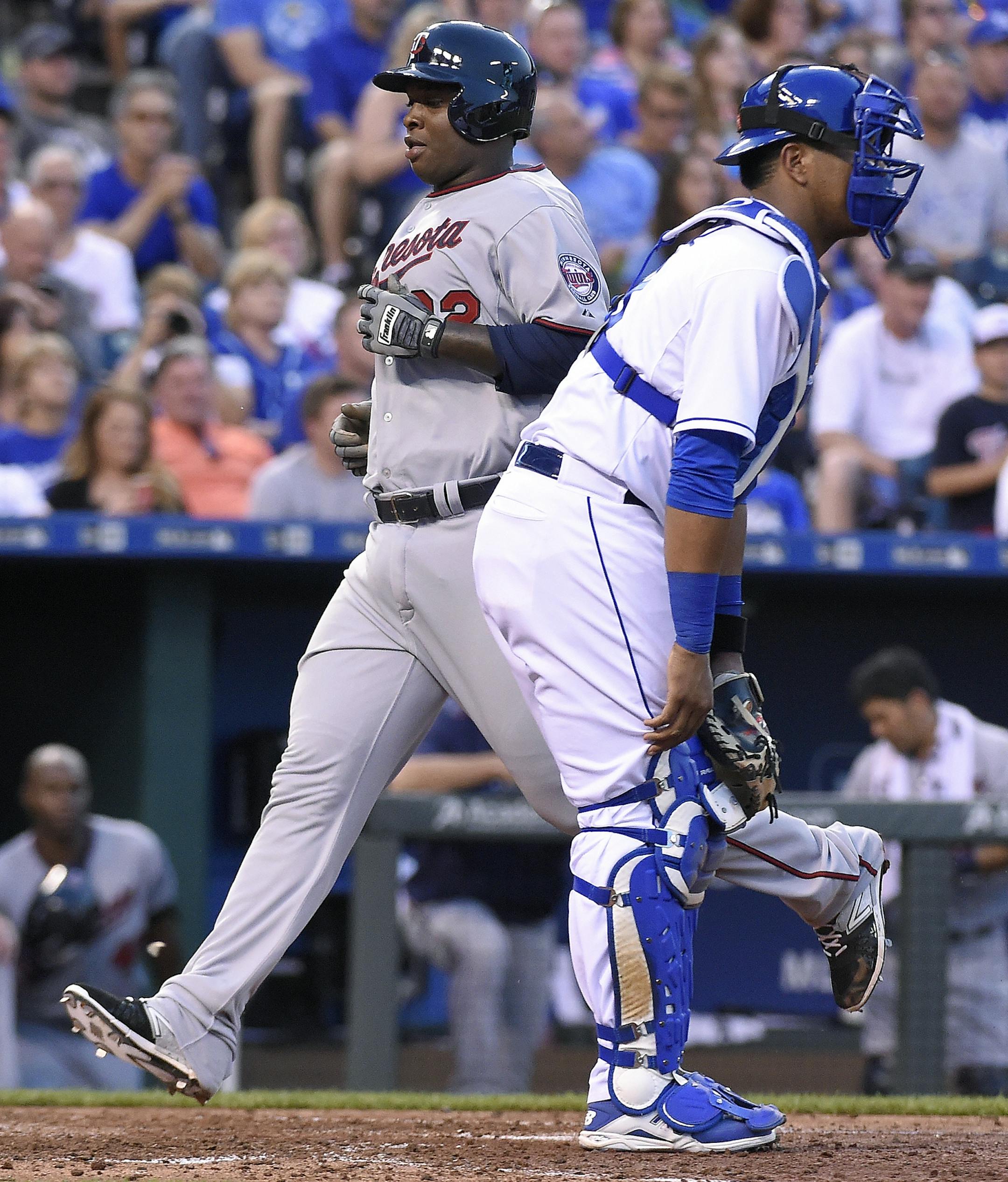 The Minnesota Twins' Miguel Sano scores behind Kansas City Royals catcher Salvador Perez on a sacrifice fly by Aaron Hicks in the fifth inning on Friday, July 3, 2015, at Kauffman Stadium in Kansas City, Mo. (John Sleezer/Kansas City Star/TNS)