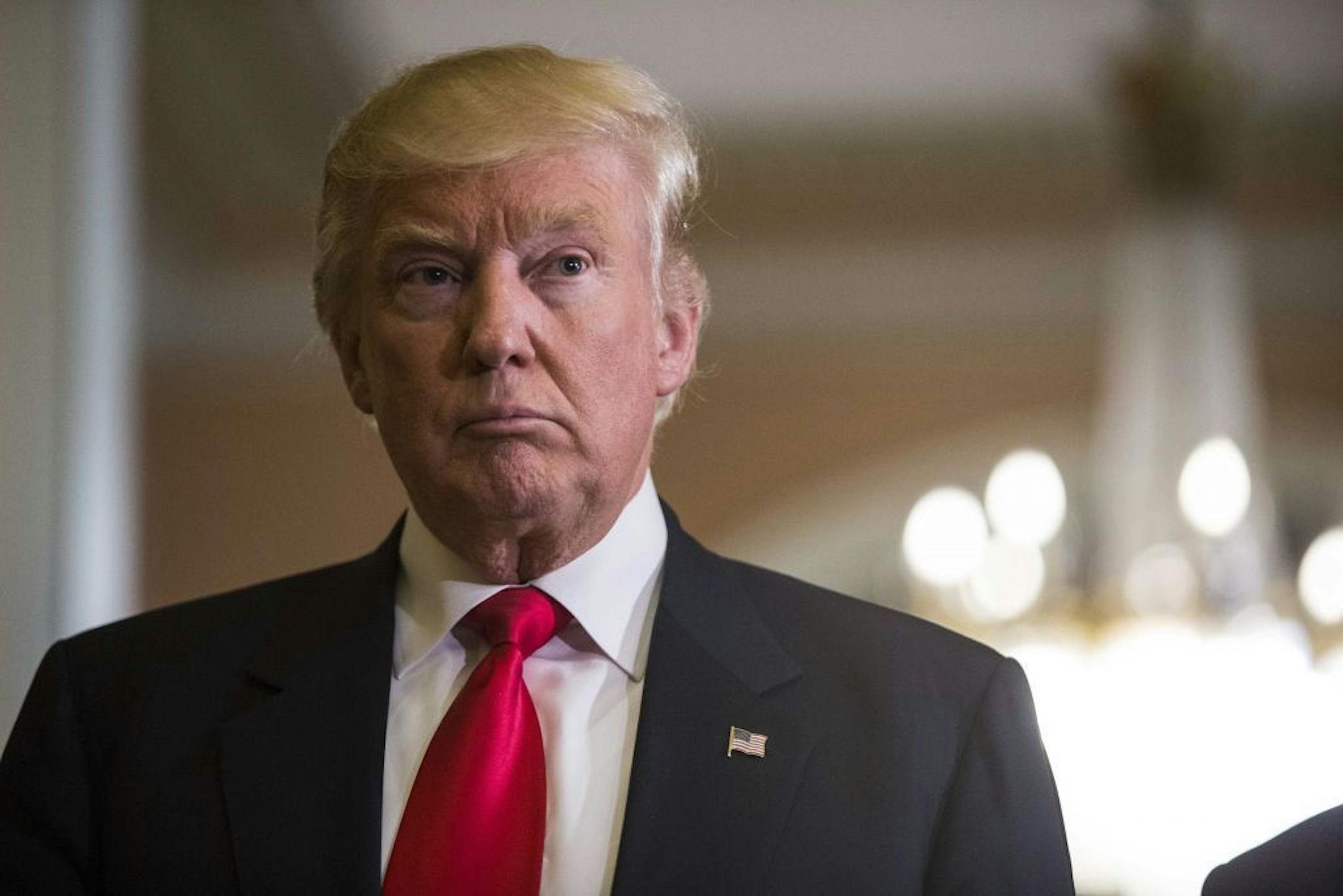 President-elect Donald Trump listens to a question Thursday during a visit to Capitol Hill in Washington.