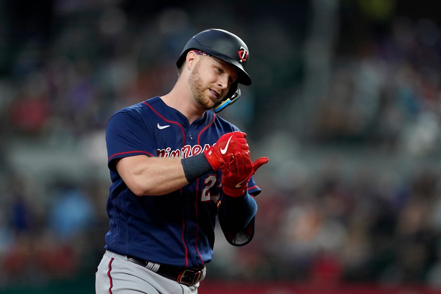 Minnesota Twins' Ryan Jeffers celebrates his solo home run as he rounds third in the sixth inning of a baseball game against the Texas Rangers, Sunday, July 10, 2022, in Arlington, Texas. (AP Photo/Tony Gutierrez)