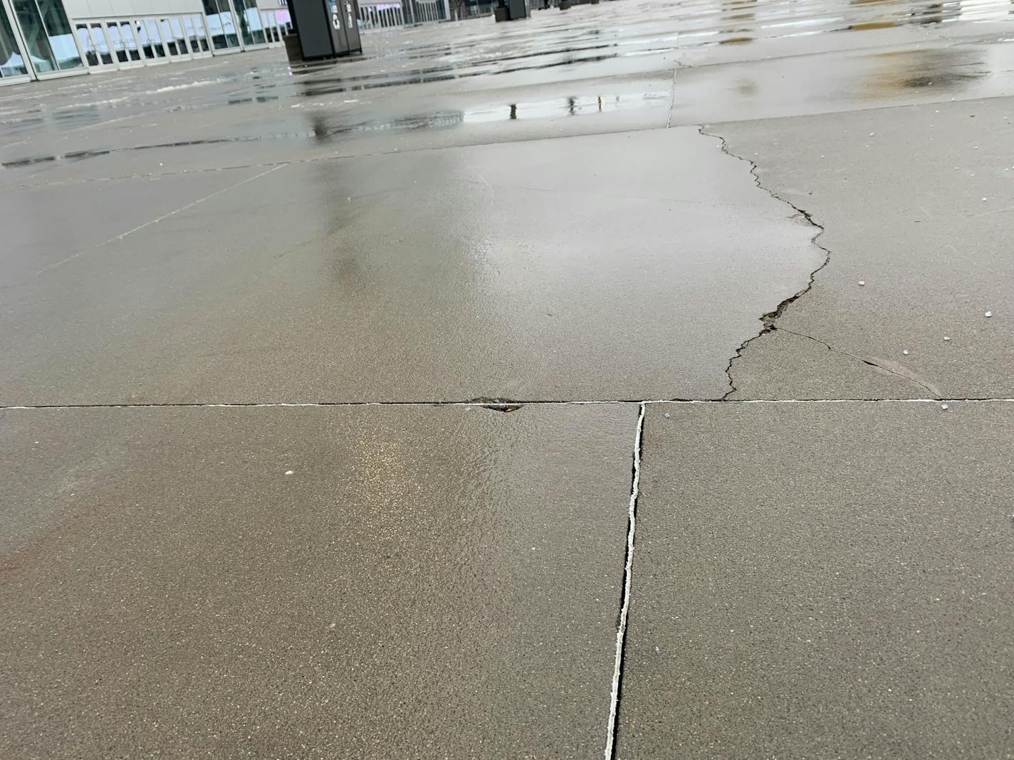 Cracks in the concrete extend from pre-cut lines across Medtronics Plaza on the west side of U.S. Bank Stadium in Minneapolis, Minn., Wednesday, Dec. 14, 2022. The Minnesota Sports Facilities Authority on Tuesday approved a settlement with one of the contractors who designed and poured the concrete. DAVE ORRICK/STAR TRIBUNE