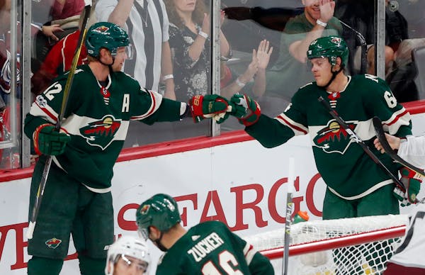 Minnesota Wild's Eric Staal, left, and Mikael Granlund celebrate Granlund's power-play goal off Colorado Avalanche goalie Jonathan Bernier on Saturday
